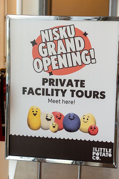 Edmonton Commercial Photography - signage directs guests to the location of facility tours for the grand opening of the Little Potato Companys's grand opening in Leduc