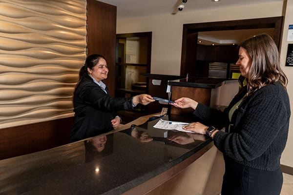 Edmonton Commercial Photography - front desk staff assist a guest checking into the hotel